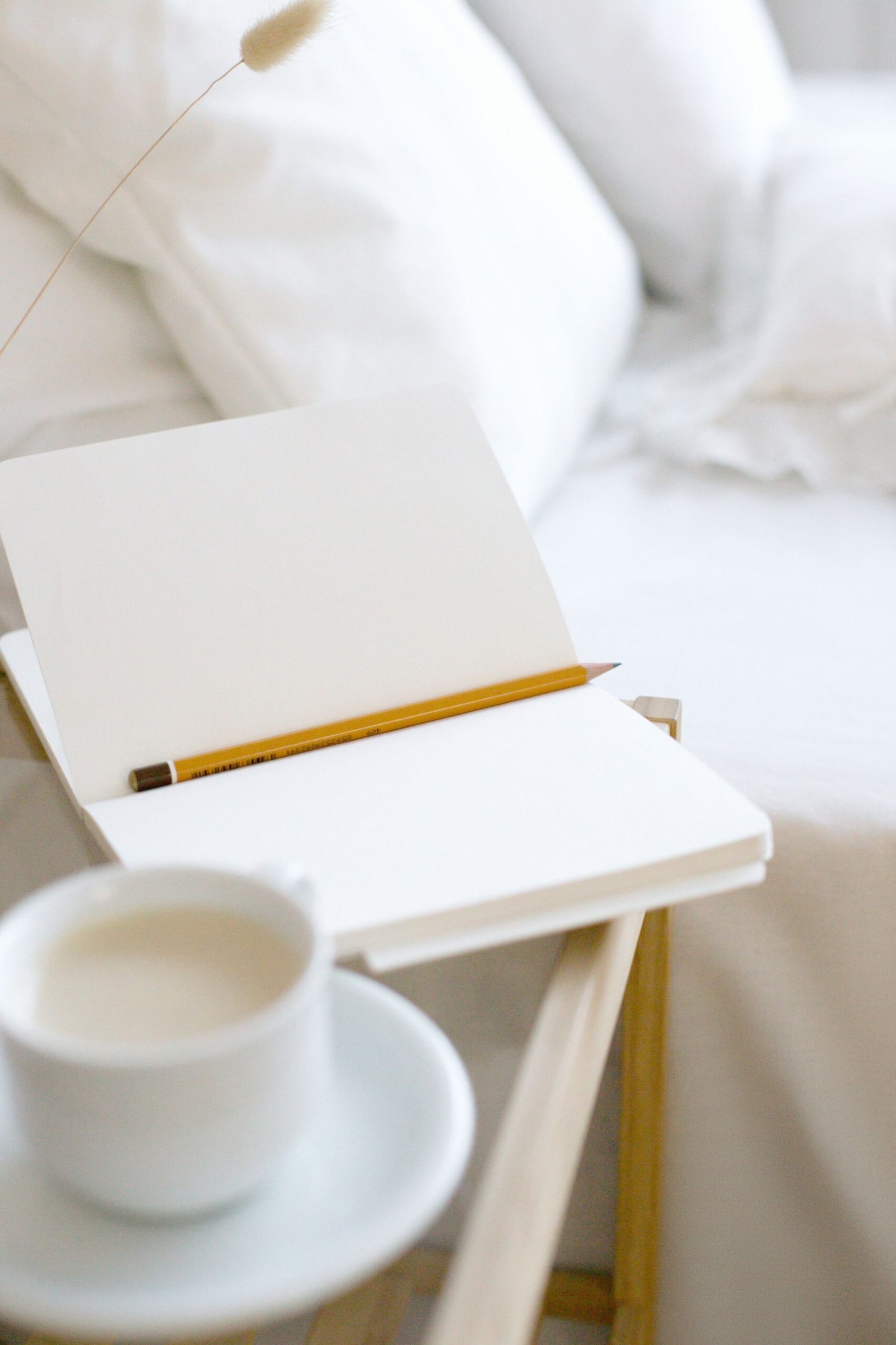 Open notebook and pencil on a bedside table for daily routine planning