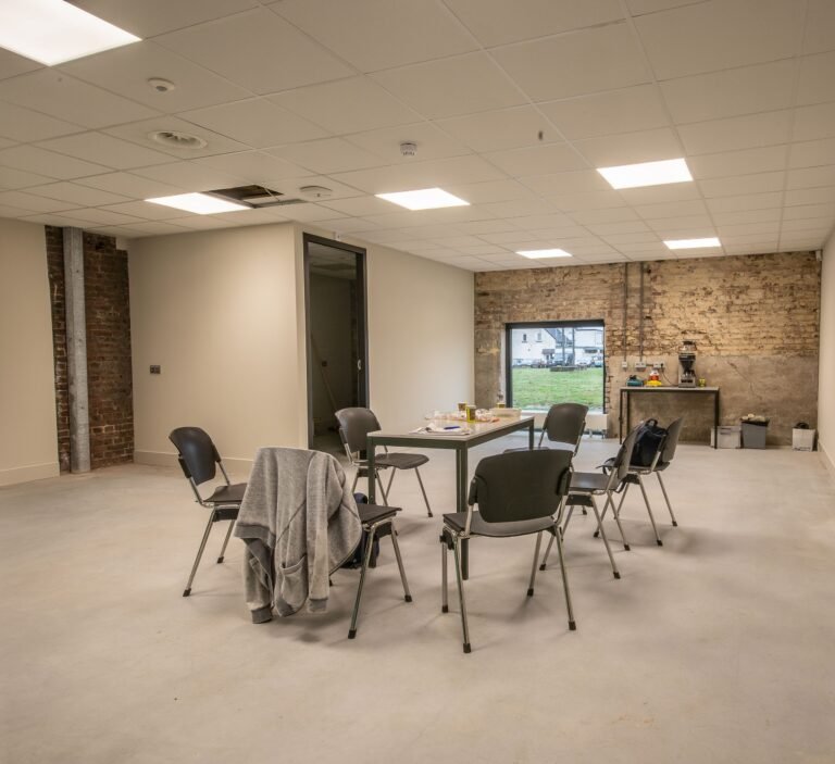 Empty meeting table and chairs in a bright private room