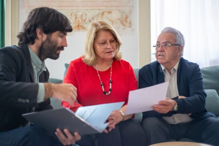 Senior couple reviewing documents with a professional advisor