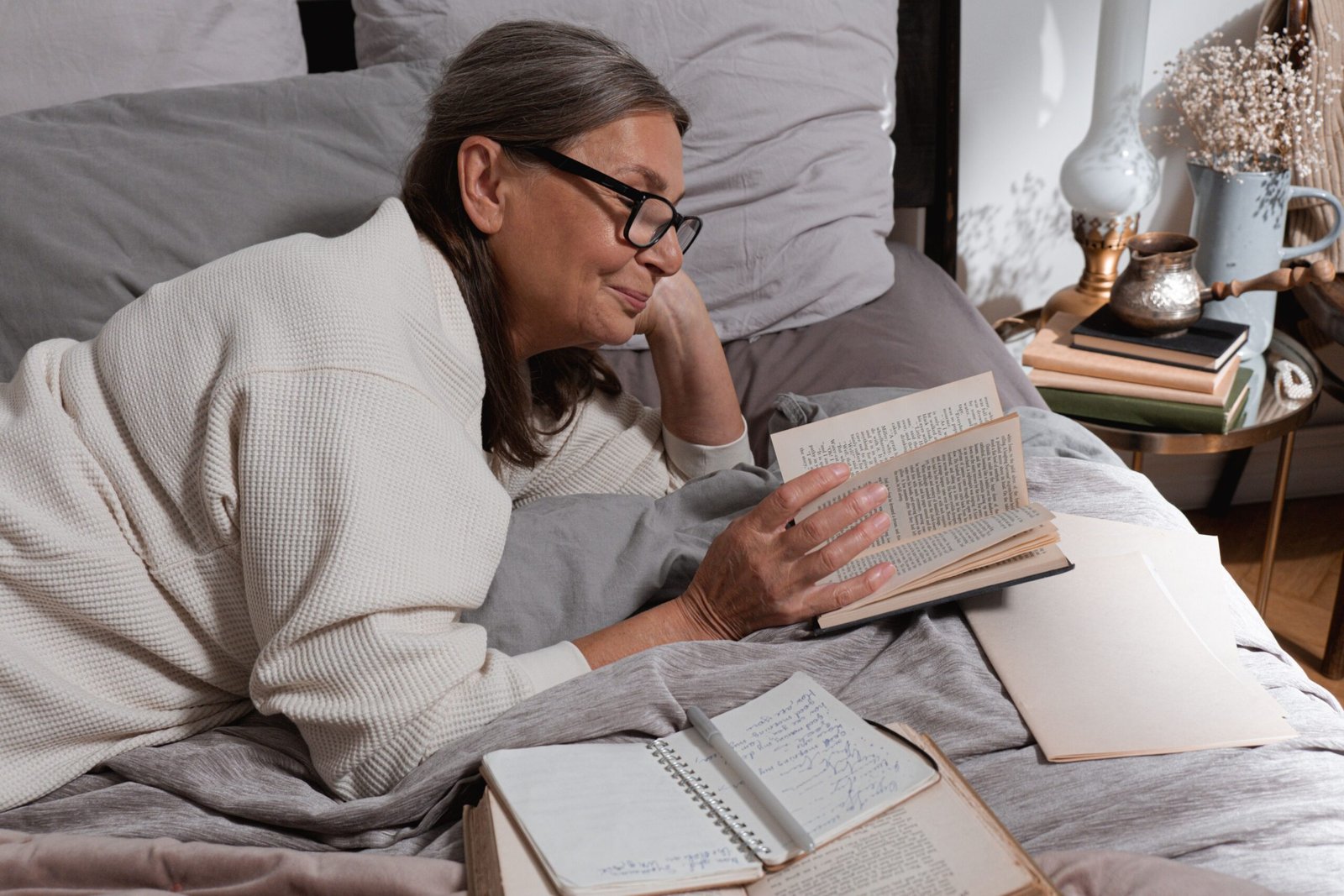 Older woman reading in bed while awake at night