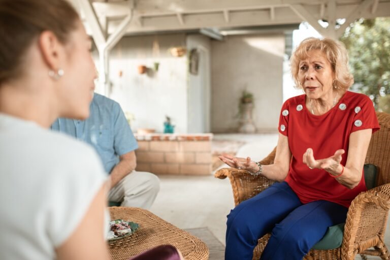 Older woman talking with her adult daughter in a calm home setting