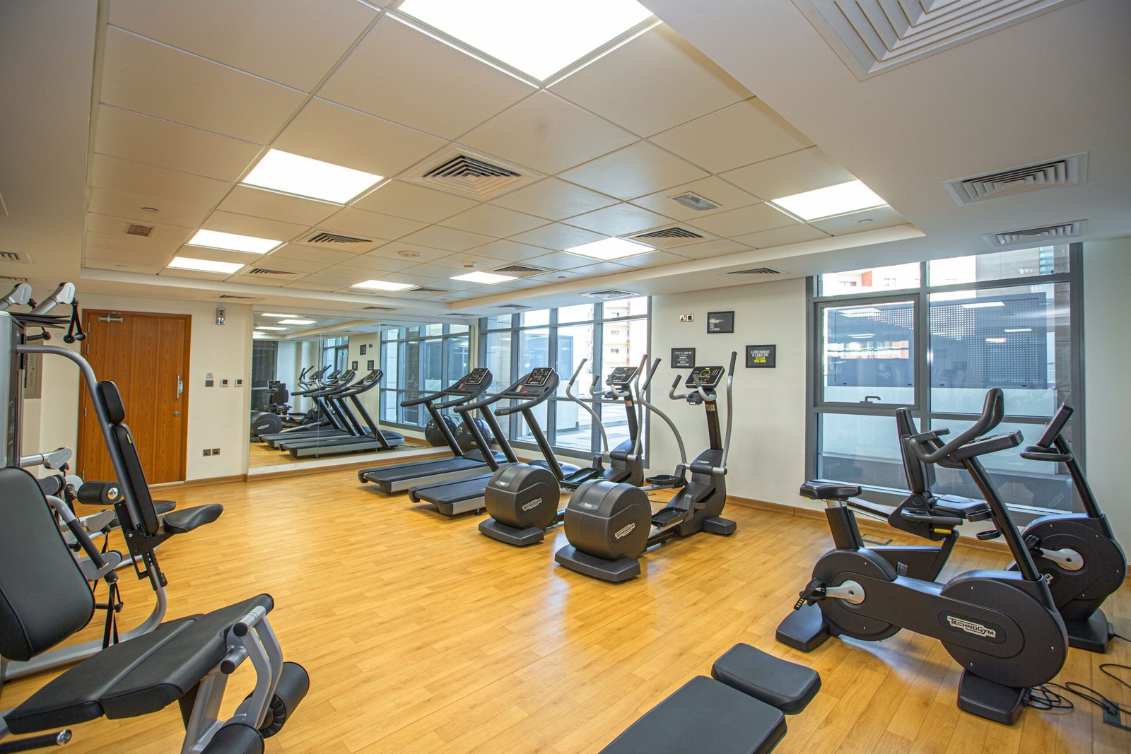 Empty rehabilitation room with exercise equipment arranged for therapy.