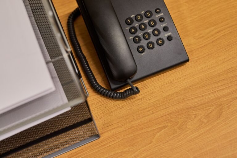 Office desk with a telephone and organized documents.