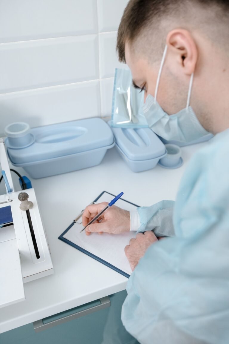 Healthcare professional writing notes on a clipboard.