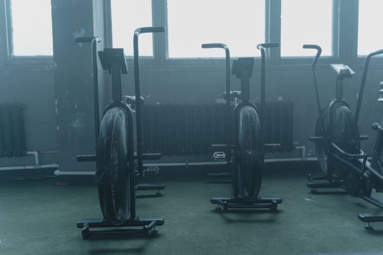 Exercise equipment lined up in an empty indoor training space.