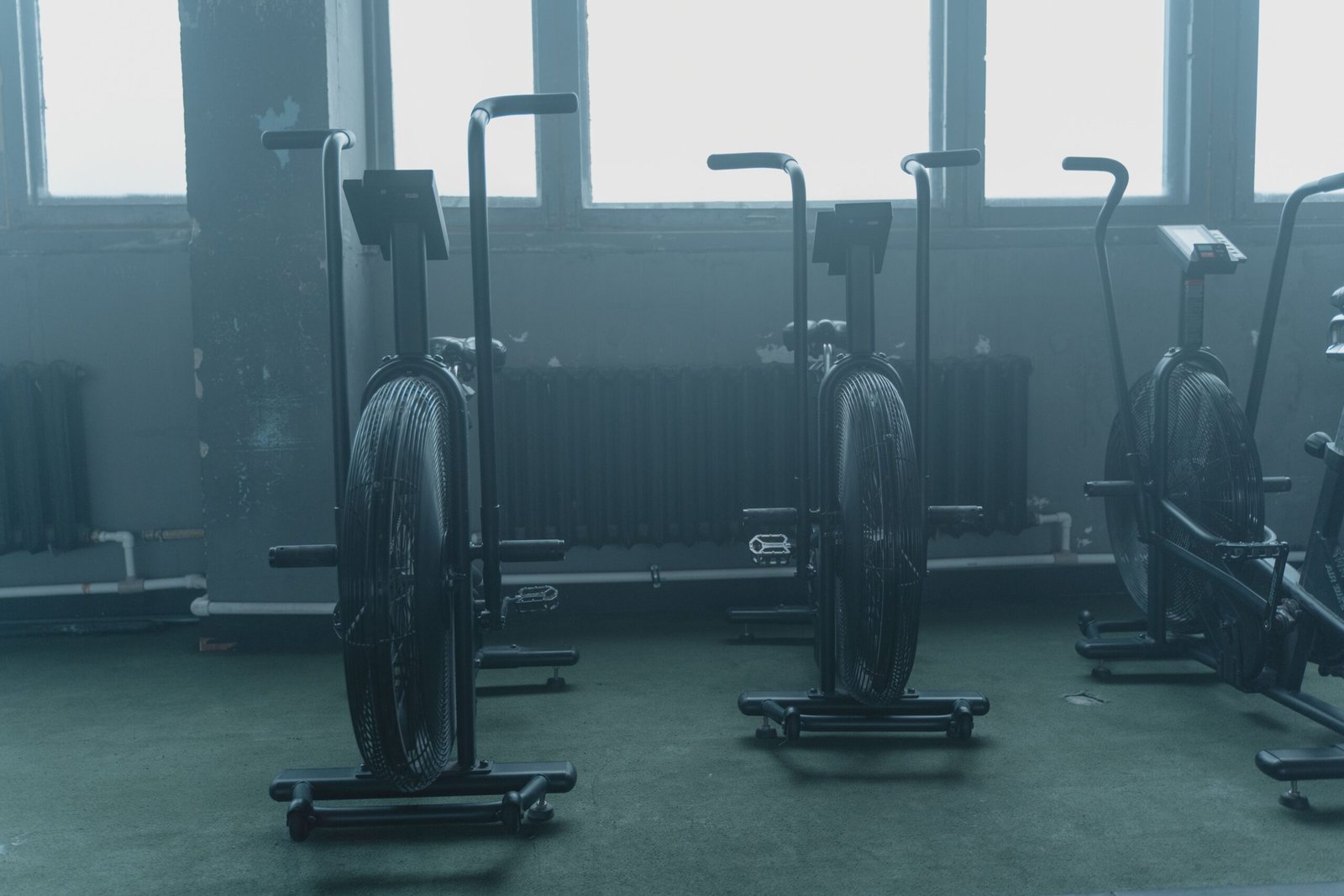 Exercise equipment lined up in an empty indoor training space.