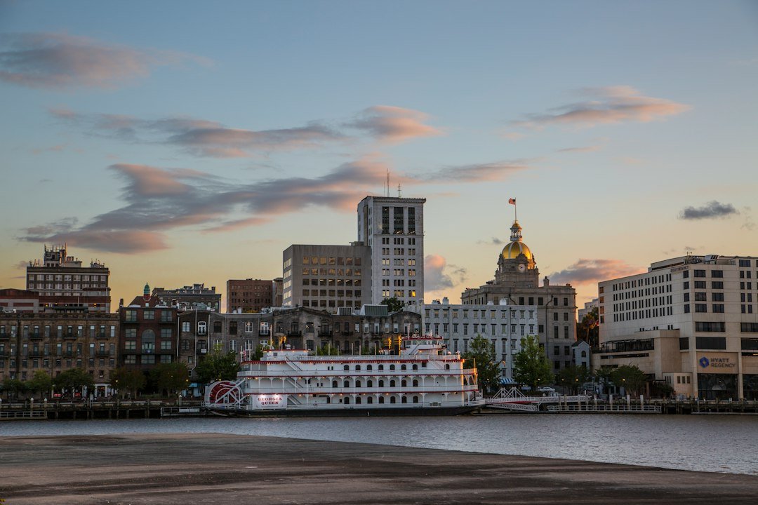 Savannah riverfront and city buildings at sunset