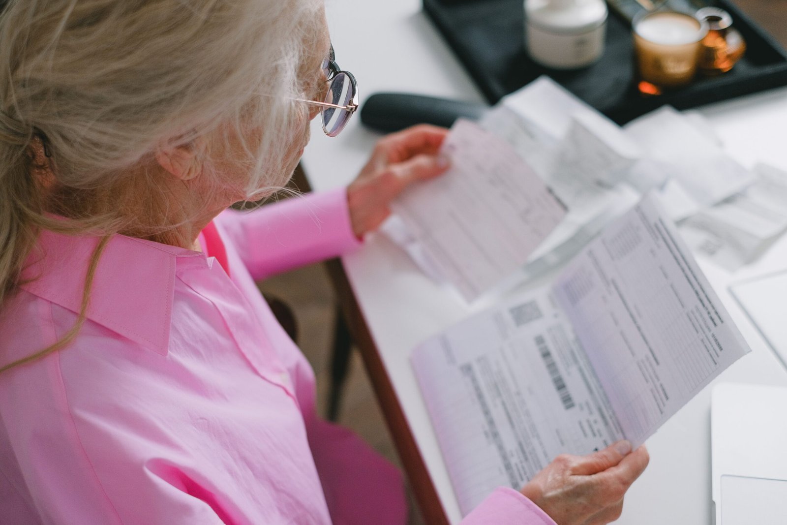 Older woman reviewing important papers at a table
