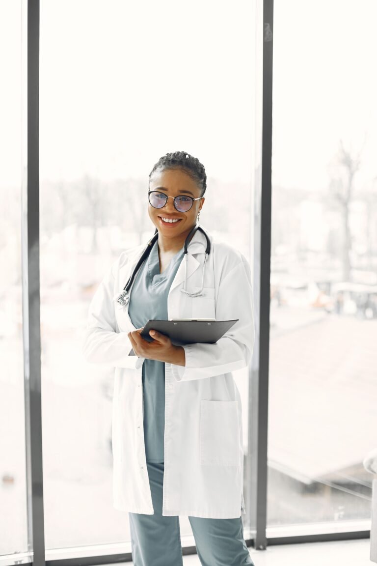Smiling healthcare professional holding a clipboard.