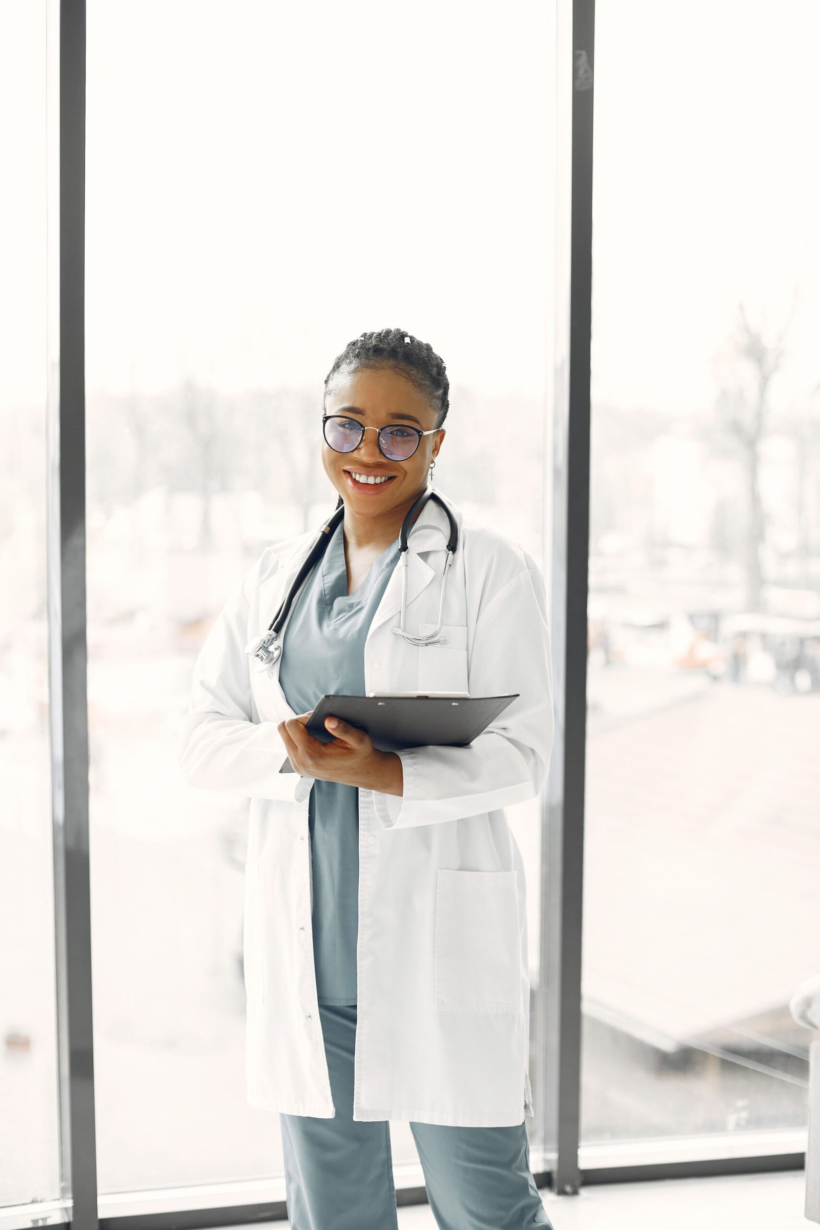 Smiling healthcare professional holding a clipboard.
