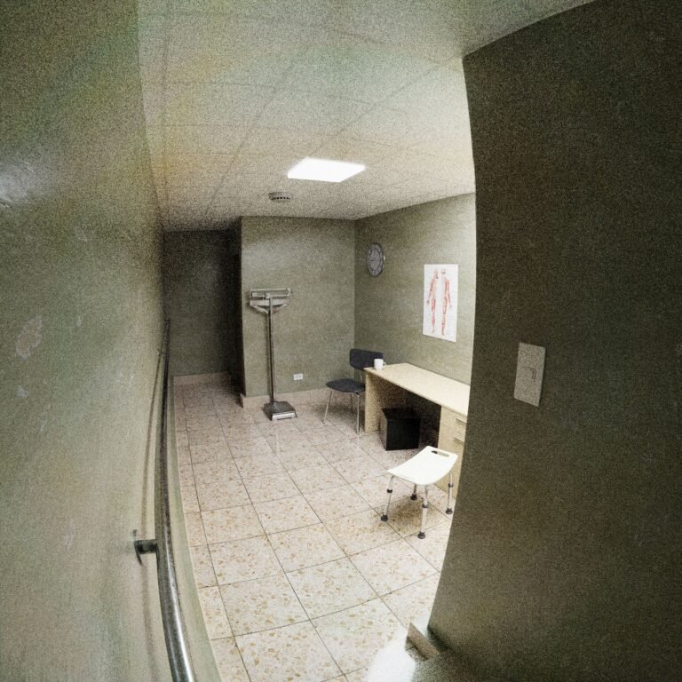 Empty medical office with chairs, desk, and clinical equipment