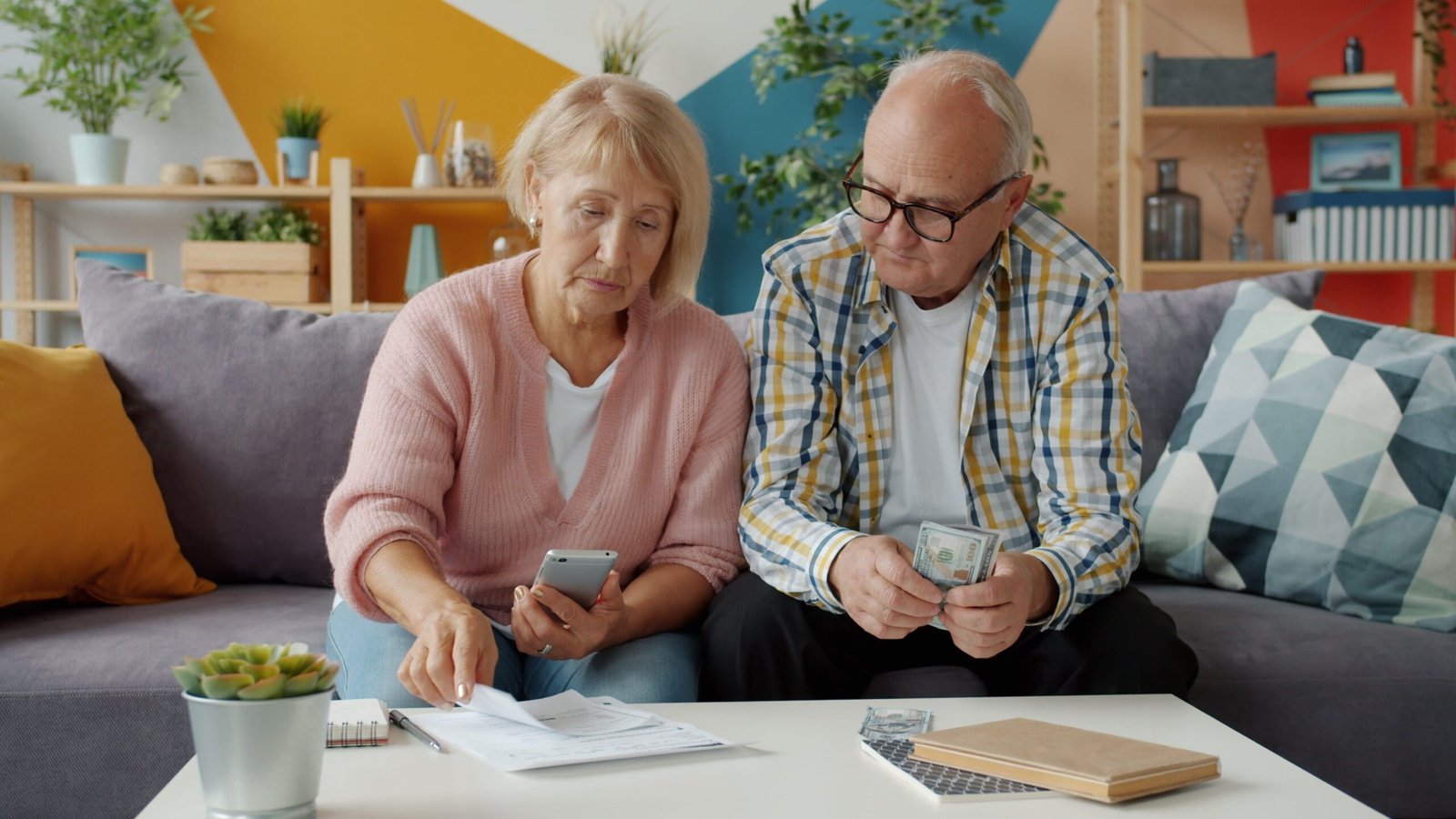 Older couple reviewing household finances together at home