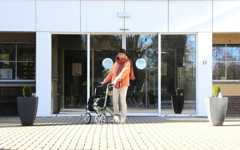 Older adult with a walker entering a residential care building