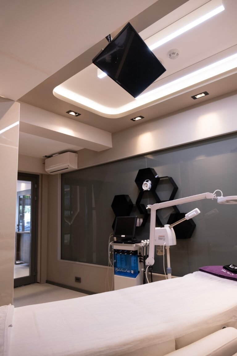 Modern clinical room with medical equipment and a treatment bed