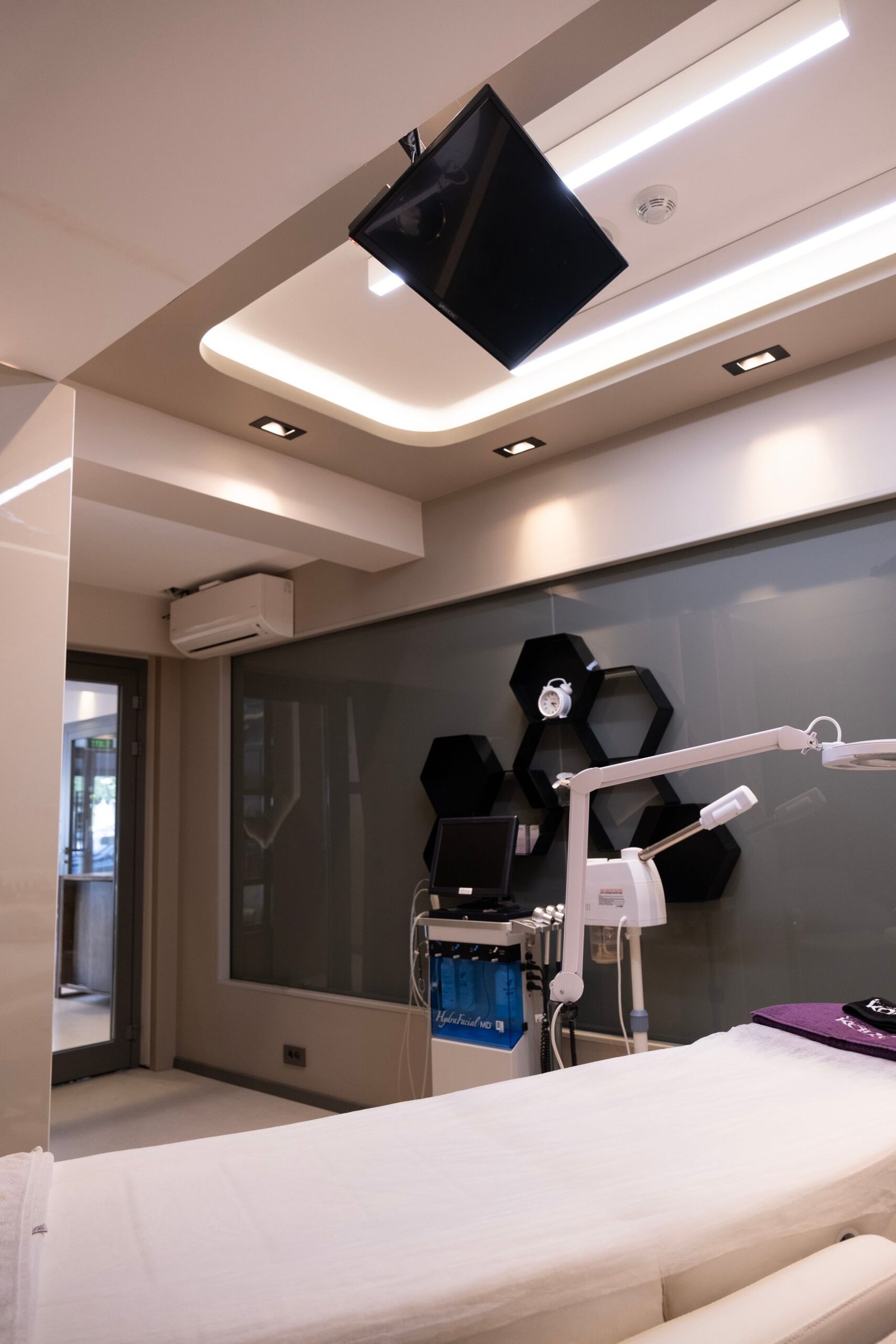 Modern clinical room with medical equipment and a treatment bed