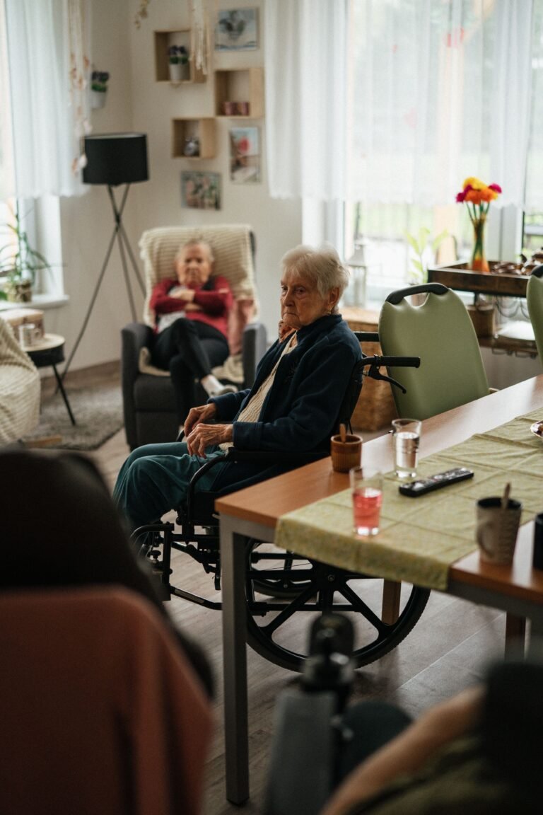 Older adults relaxing together in a nursing-home room.
