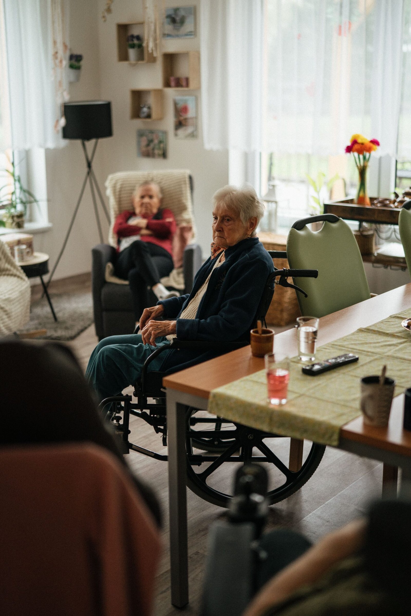 Older adults relaxing together in a nursing-home room.