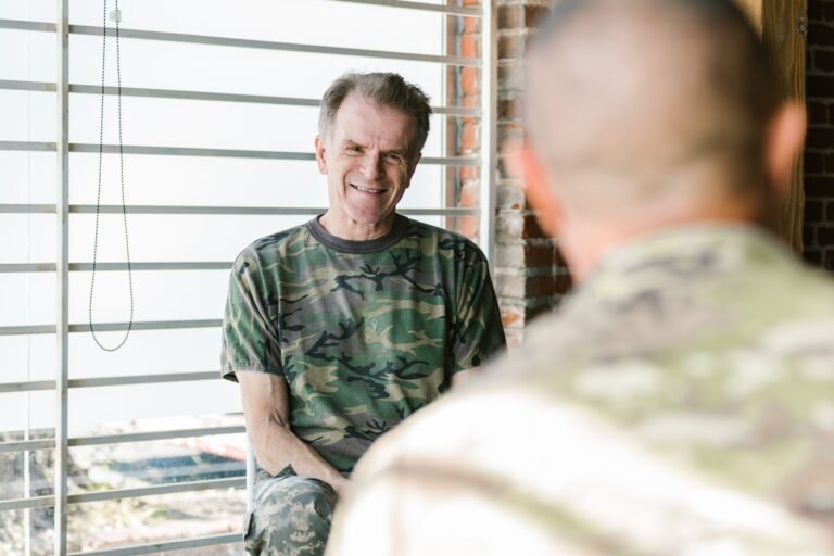 Older military veterans participating in a supportive indoor conversation